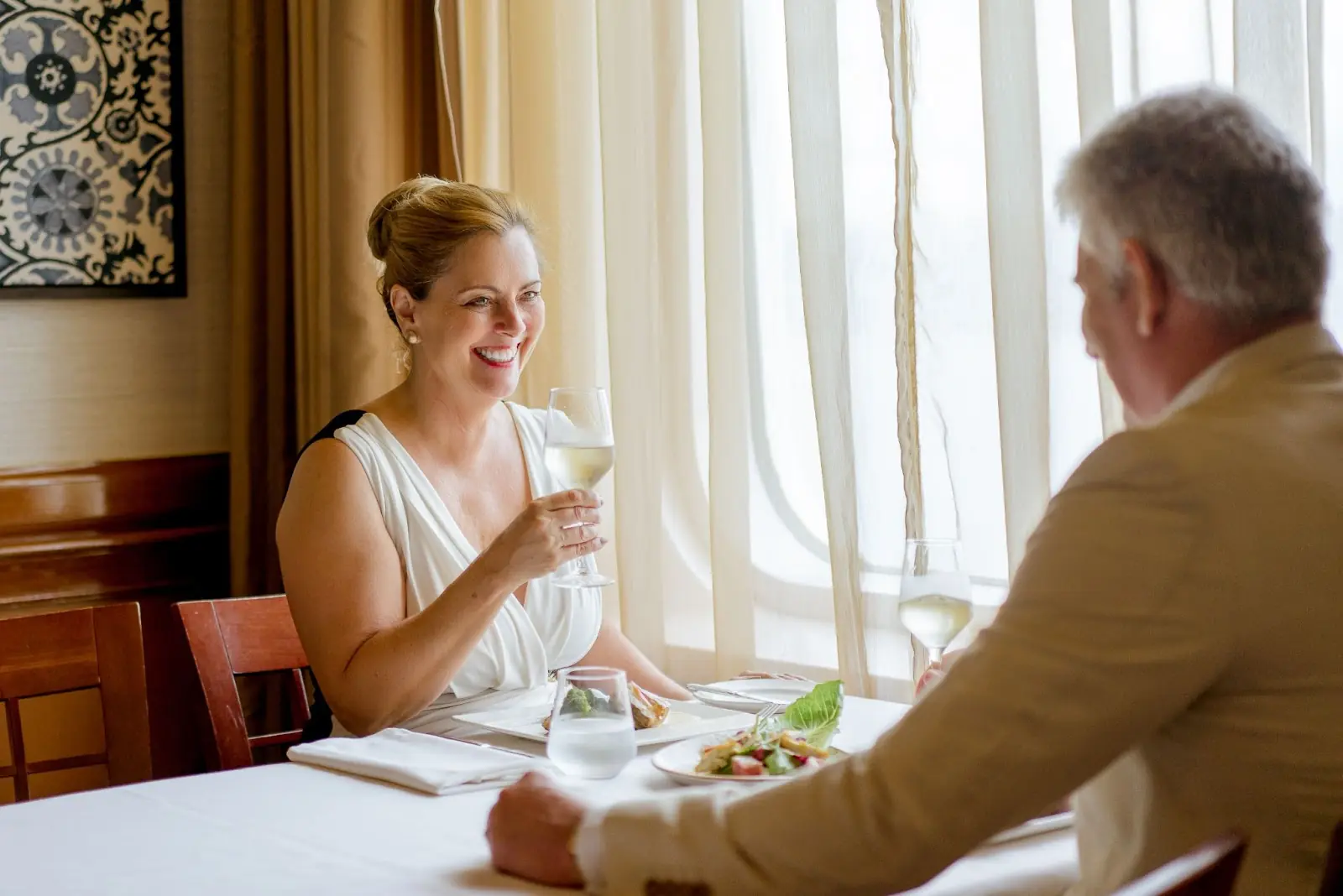Guests enjoying dinner onboard Ambassador Cruise Line