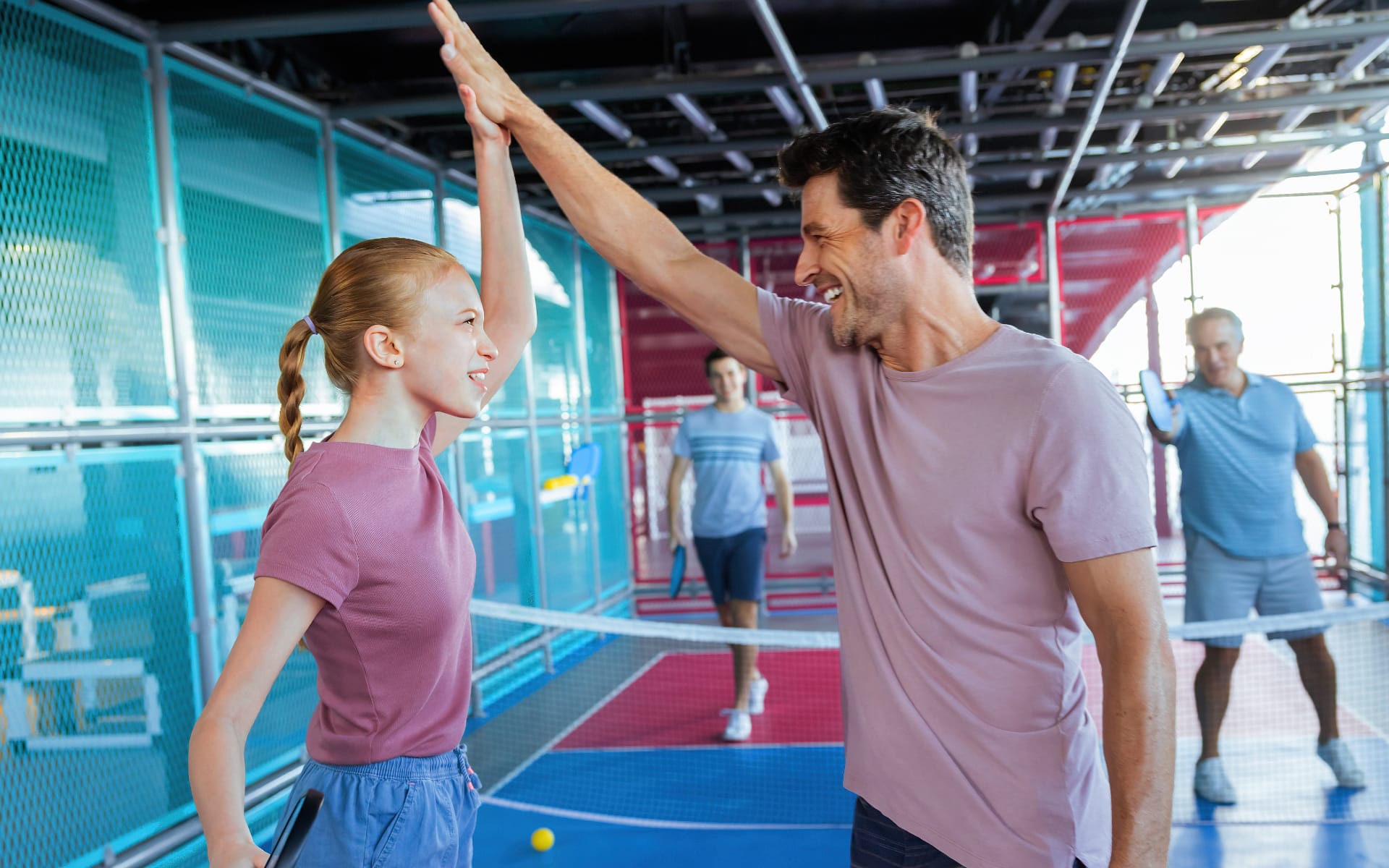 People playing pickleball on a cruise ship sports court