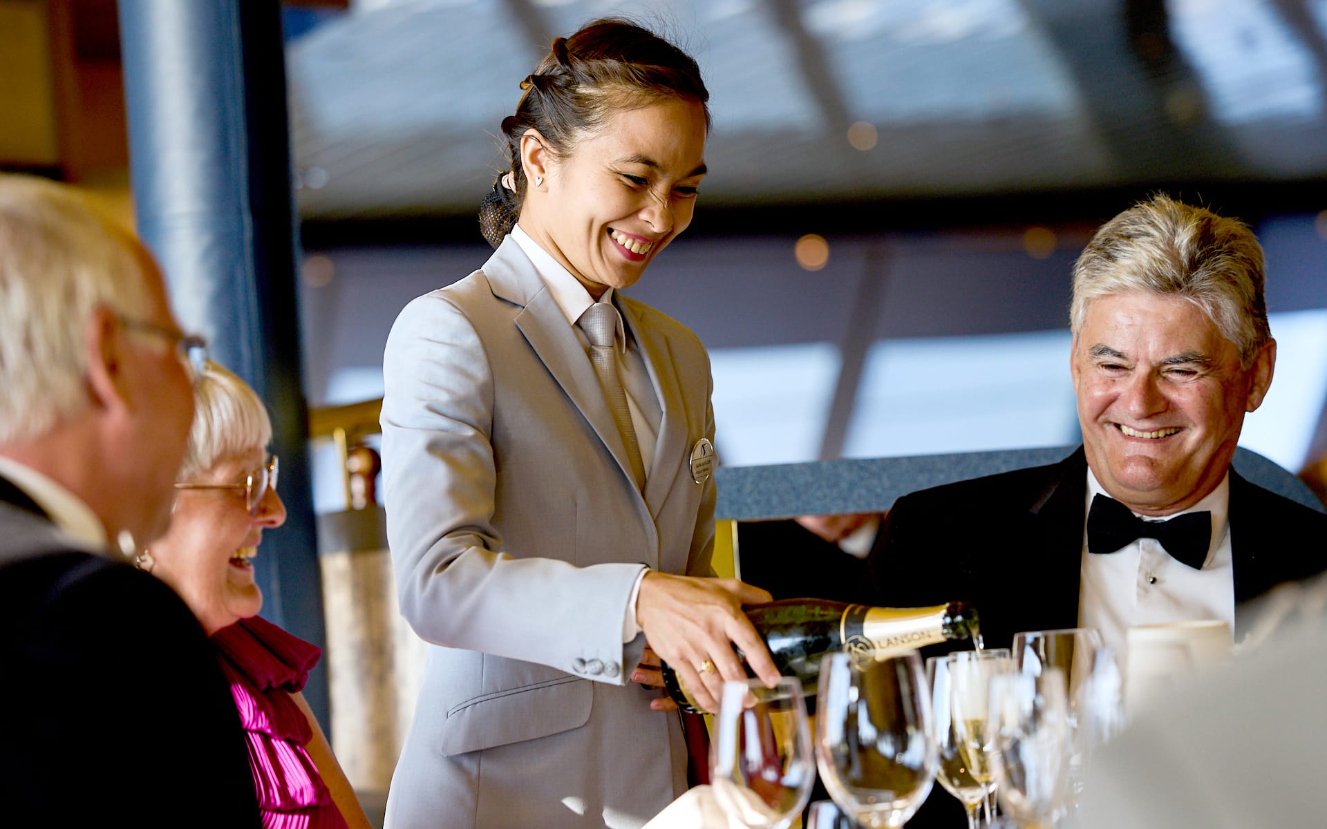 Guests enjoying a drink in a cruise ship's fine dining restaurant