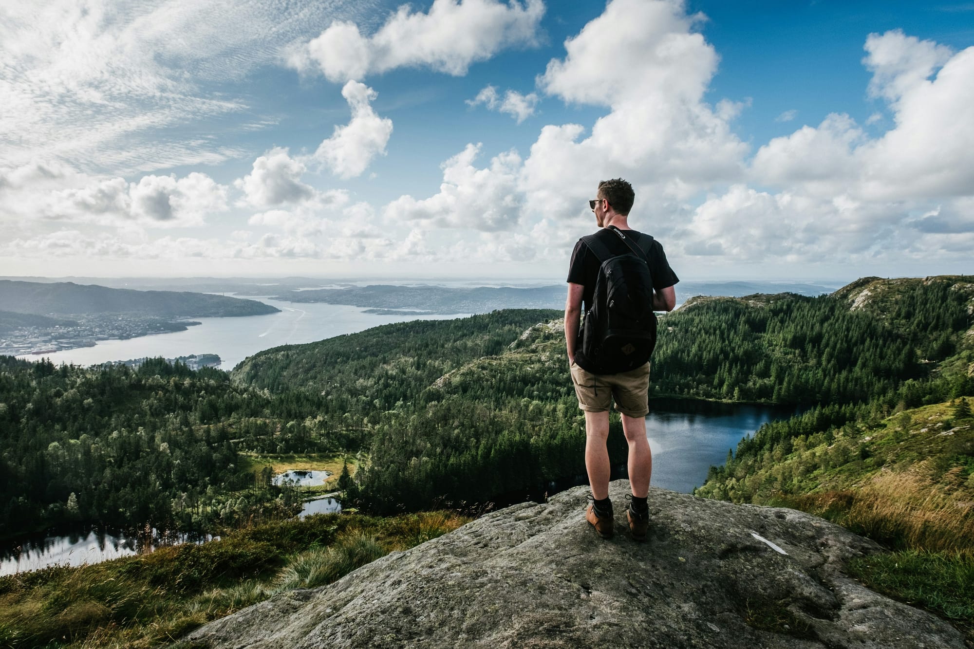 A man looking out at a fjord in Bergen, Norway