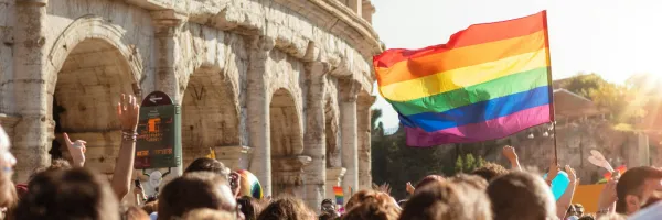 A Pride flag flying during a Pride parade